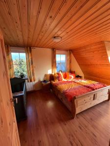 a bedroom with a large bed in a wooden room at Haus Boddenperle in Breege