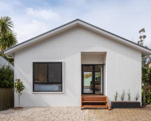 a white house with a large glass door at Moritz Hahndorf Boutique Guest House in Hahndorf