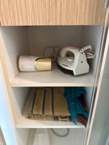 a cabinet with a telephone and other items in it at The Viana Apartment 6 in Kota Bharu