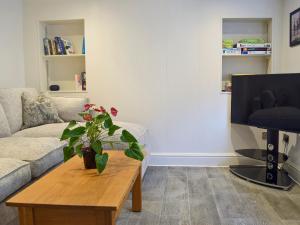 a living room with a couch and a coffee table at Bristol House in New Quay