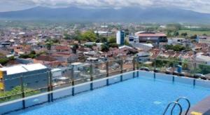 a view from the roof of a building with a swimming pool at Java Lotus Hotel Jember in Jember