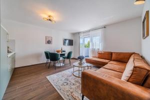 a living room with a couch and a table at Plitvice Lakes Apartments&Rooms in Grabovac