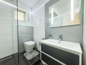 a bathroom with a toilet and a sink and a mirror at FEWO Frauenschuh in Steibis +3 photos