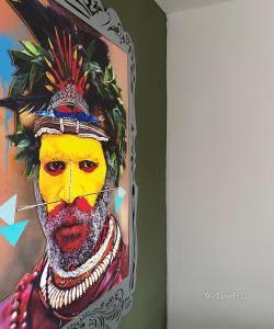 a painting of a man with a yellow face at Boutique 1 Bedroom Duplex Suite on Marina-304 in Hull