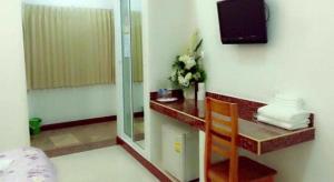 a hotel room with a desk and a television at N-Joy Place in Surin +57 photos
