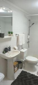 a white bathroom with a toilet and a sink at Casa O&A in Cristian +45 photos