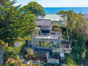 an aerial view of a house with the ocean at The Paint Box in Raumati South