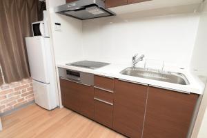 a kitchen with a sink and a refrigerator at Shinjuku NY House 2 in Tokyo