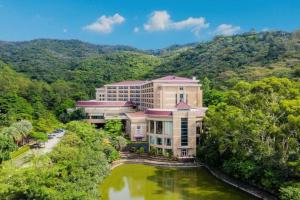 an aerial view of a building next to a river at The Lotus Villa Changan Dongguan in Dongguan