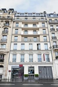 a large white building with lots of windows at Mercure Paris Gare du Nord in Paris