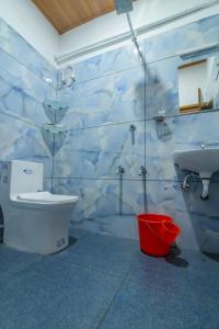 a bathroom with a toilet and a sink at Star Inn in Cochin