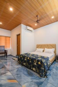 a bedroom with a bed and a wooden ceiling at Star Inn in Cochin