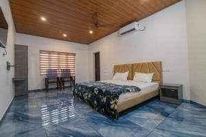 a bedroom with a bed and a table and chairs at Star Inn in Cochin