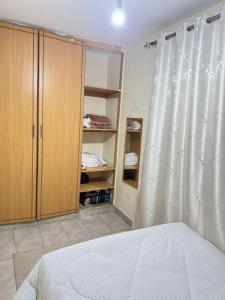 a bedroom with a bed and a closet and curtains at The insight homes in Nairobi