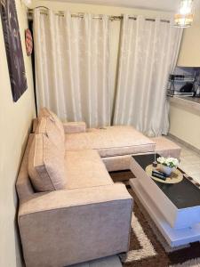 a living room with a couch and a table at The insight homes in Nairobi