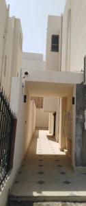 an empty hallway of a white building with a fence at Aurum studio in Riyadh +2 photos