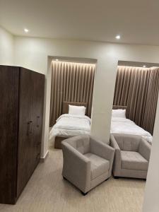 a bedroom with a bed and a chair and a couch at Midtown Lweibdeh Hostel in Amman