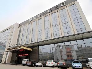 a large building with cars parked in a parking lot at Qingdao Minlian Kaixuan Hotel in Qingdao
