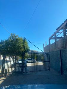 a gate with a car parked in a parking lot at Mini loft nogales in Heroica Nogales