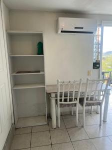 a dining room with a table and two chairs at Mini loft nogales in Heroica Nogales