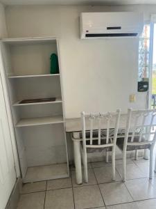 a kitchen with a table and a chair at Mini loft nogales in Heroica Nogales +2 photos