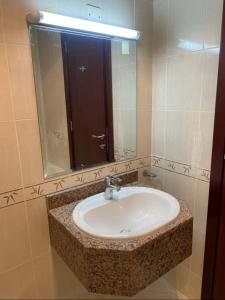 a bathroom with a sink and a mirror at Heavenly stay in Ajman 
