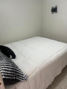 a white bed in a room with at Mini loft nogales in Heroica Nogales