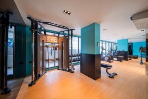 a gym with cardio equipment in a building at 2Bdr Cozy Apartment in heart of BangTao in Ban Thalat Choeng Thale