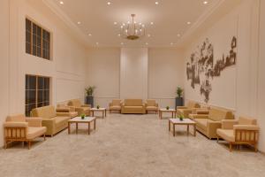 a waiting room with couches and tables at Lemon Tree Hotel Morbi 