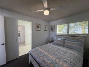 a bedroom with a bed and a ceiling fan at Spinnaker Seas Unit 8 in Caloundra +8 photos