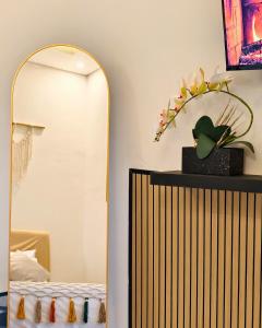 a mirror in a room with a bed and a table at Sadewa Villa Batu in Punten +12 photos