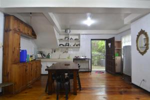a kitchen with a wooden table in a room at Carlos Residence in Baguio
