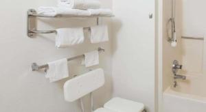 a bathroom with a white toilet and towels at Super 8 By Wyndham Wayne in Wayne +64 photos