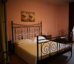 a bedroom with a bed with a metal frame at Bed & Breakfast l'Albergo Di Ieri in Serravalle di Chienti