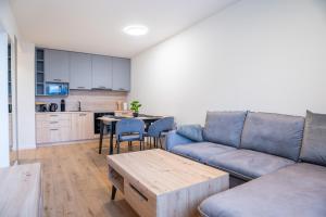 a living room with a couch and a table at Luxapartment ll Krivá in Košice