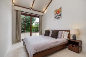 a bedroom with a large bed and a window at Exclusive townhouse Beachside Excellent location in Sanur +34 photos