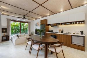 a kitchen and living room with a table and chairs at Exclusive townhouse Beachside Excellent location in Sanur