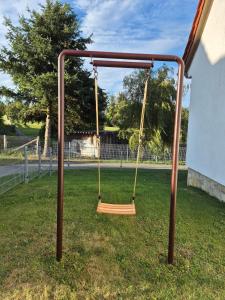 a swing set in a park with a yard at Ferienhaus Wiesenblick in Hüttenrode
