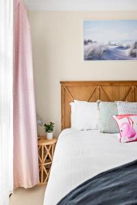 a bedroom with a bed with a wooden headboard at Tranquil Queen Room - Centrally Located at Milperra - Shared Bathroom in Panania +36 photos