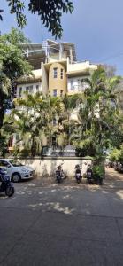a group of motorcycles parked in front of a building at New White House Hotel in Pune