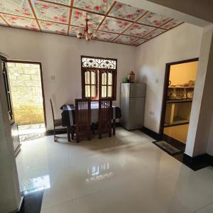 a living room with a dining table and a ceiling at House of Dorms in Ahangama +1 photo
