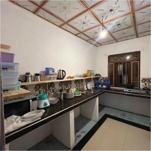 a kitchen with a counter with dishes on it at House of Dorms in Ahangama