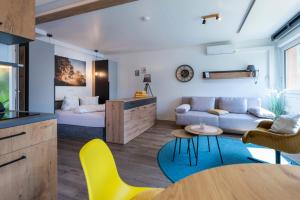 a living room with a bed and a table at Stadel Chalet Kunterbunt in Ried im Oberinntal