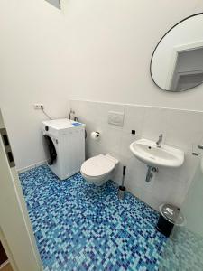 a bathroom with a toilet and a sink and a mirror at Bavaria Home Modern Living in Geisenfeld