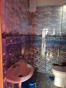 a bathroom with a shower and a sink in it at Sittong Valley Homestay in Mangpu