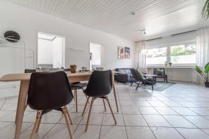 a kitchen and living room with a wooden table and chairs at M3 Workers Home in Bocholt