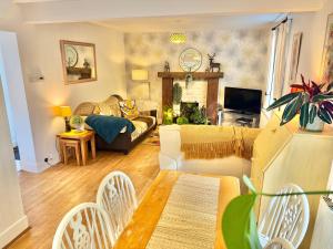 ein Wohnzimmer mit Couch und Tisch in der Unterkunft Gateman's Cottage - Three Bedroom Detached Home - Free Parking - Close to New Forest and Beaches in West Moors