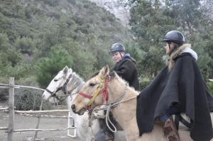 dwoje ludzi jeździ konno w obiekcie El Cielo Lodge w mieście San José de Maipo