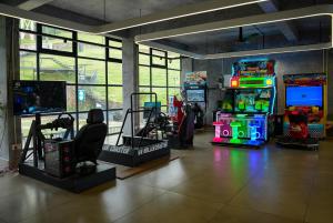a room with arcade games and video game machines at Rain Cap Resort in Wayanad
