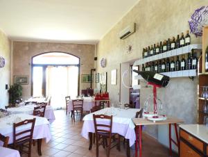 a restaurant with tables and chairs and wine bottles at Affittacamere Da Franco in Parma